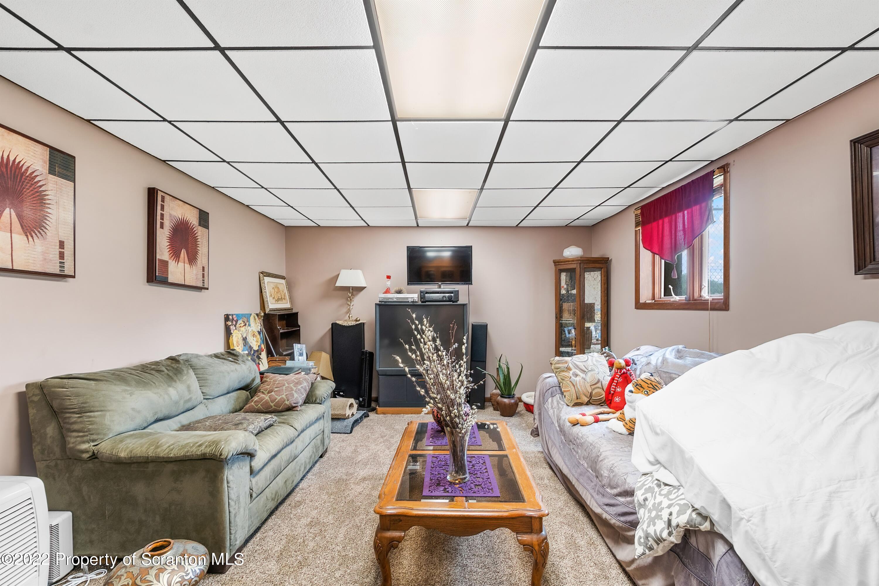 116 Hack Road Dalton, PA 18414 - Photo 28 of 33 a living room with furniture gym equipment and a flat screen tv