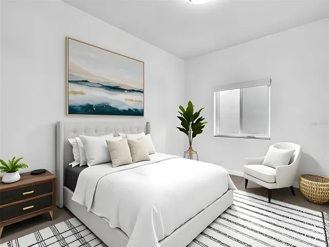 a bedroom with a bed and lamp painting on the wall