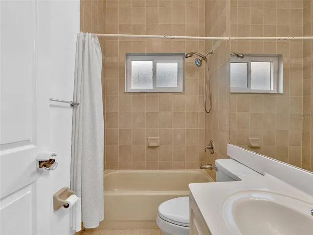 a swimming pool with patio outdoor seating and yard in the back