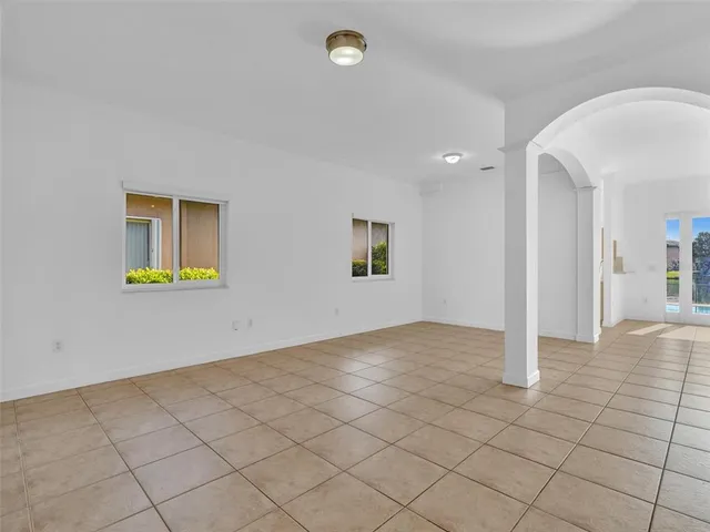 an empty room with white walls and tiles