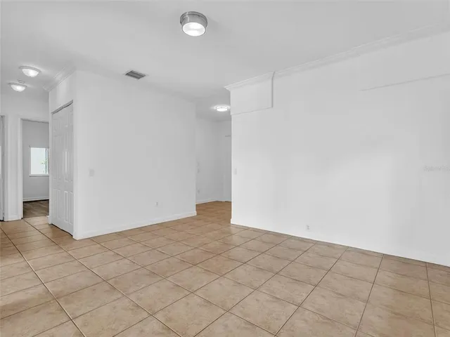 a view of a kitchen with furniture and an empty room