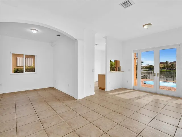 a large kitchen with stainless steel appliances a stove a sink and a refrigerator