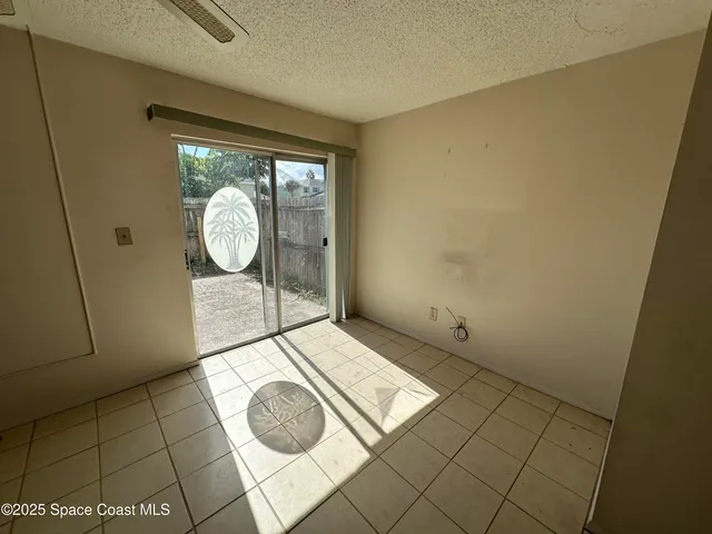 a view of a livingroom with wooden floor and glass door