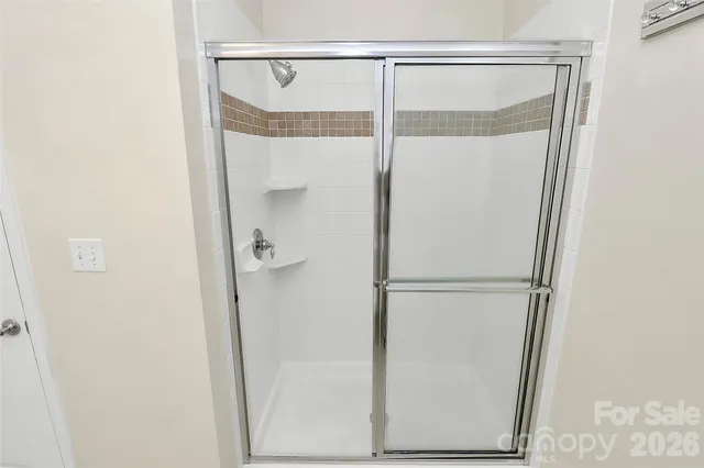 a bathroom with a glass shower door