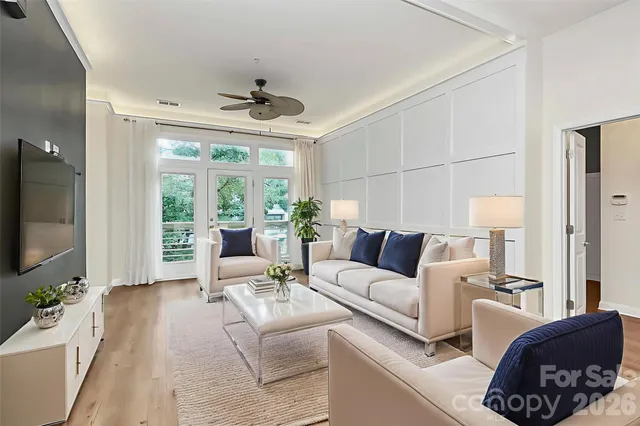 a living room with furniture large window and flat screen tv