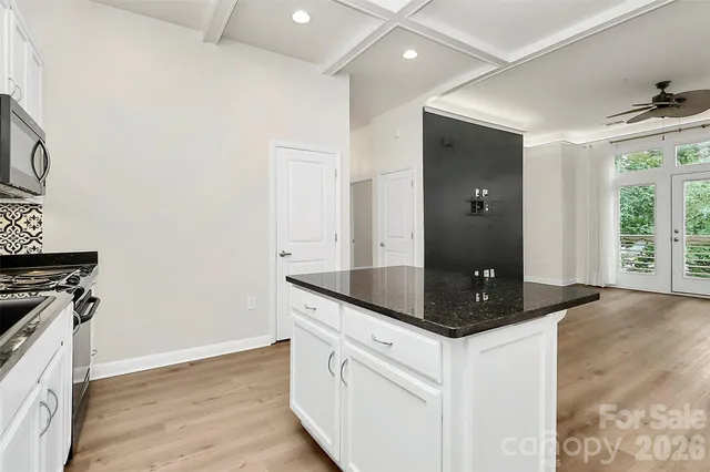 a kitchen with granite countertop a sink and a stove top oven