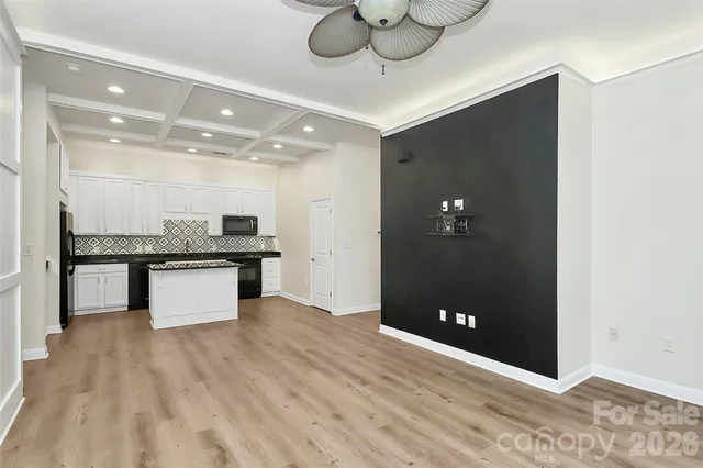 a view of kitchen with refrigerator and microwave