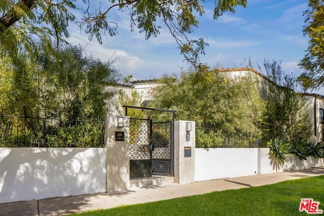 a view of a white house with a yard