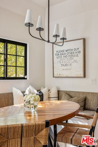 a view of a dining room with furniture and a chandelier
