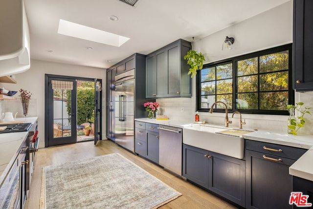 a kitchen with a refrigerator and a stove