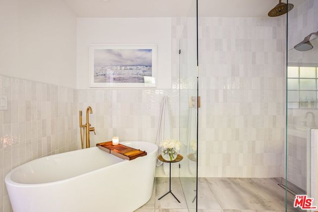 a bedroom with a bed a table and window