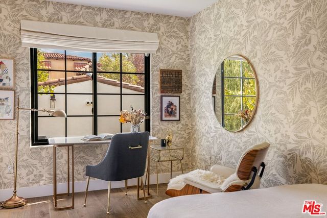 a patio with table and chairs and potted plants