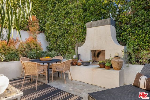 a view of a chairs and table in backyard of the house