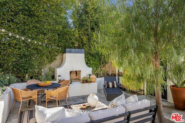 a backyard of a house with table and chairs