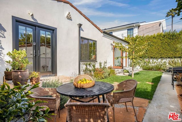 a view of backyard of house with seating space