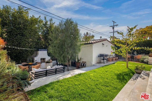 a view of a patio with table and chairs and potted plants