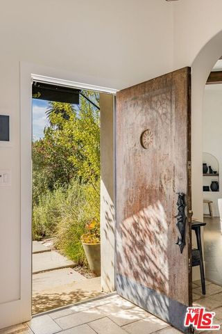 a living room with patio furniture and a fireplace