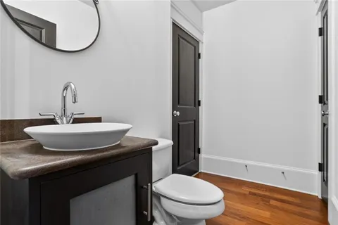 a bathroom with a sink toilet and a mirror