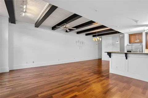 a view of a room with wooden floor and windows