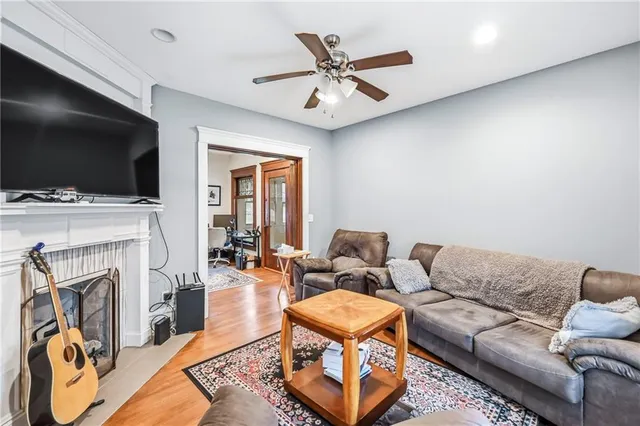a living room with furniture a flat screen tv and a fireplace