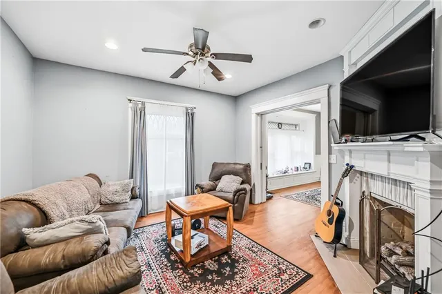 a living room with furniture a flat screen tv and a fireplace