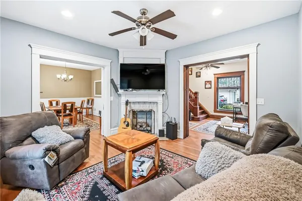 a living room with furniture a flat screen tv and a fireplace
