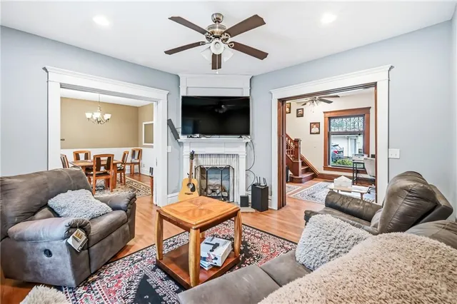 a living room with furniture a flat screen tv and a fireplace