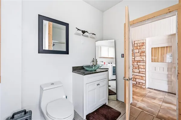 a bathroom with a toilet a sink and mirror