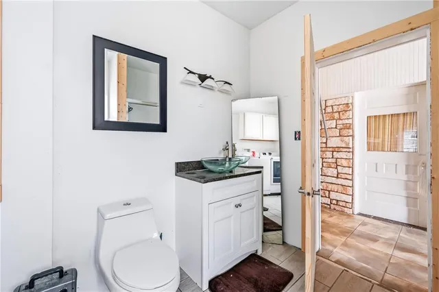 a bathroom with a toilet a sink and mirror