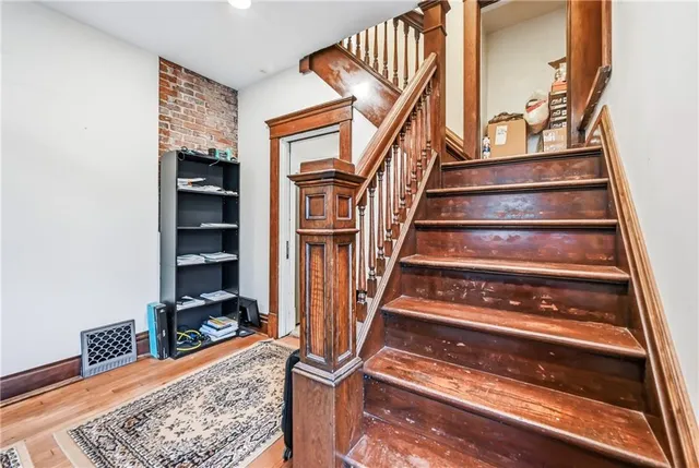 a view of staircase with wooden floor and a rug