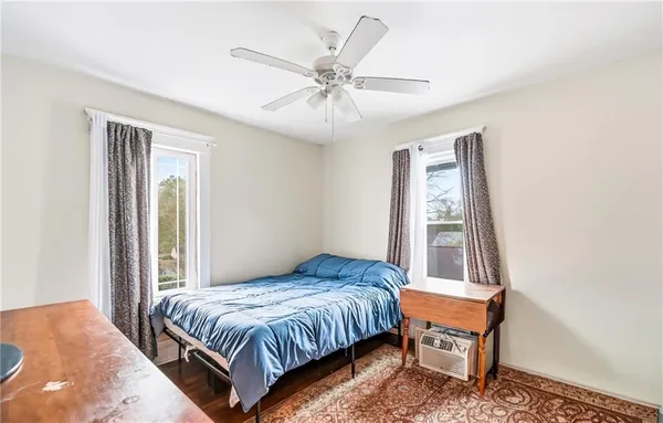 a bedroom with a bed and a window