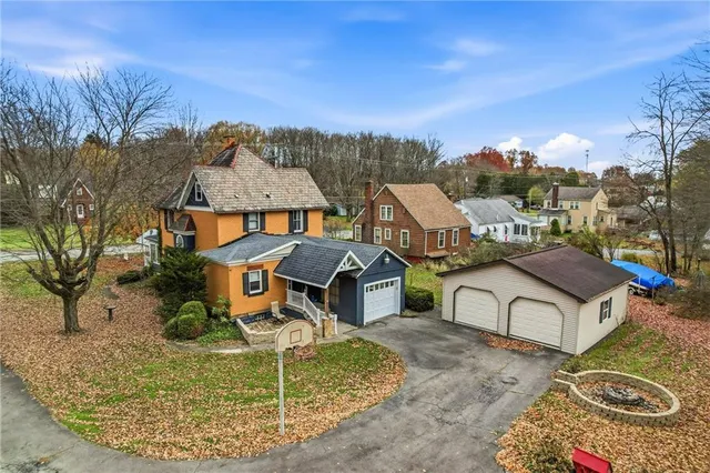 an aerial view of a house with swimming pool garden and patio