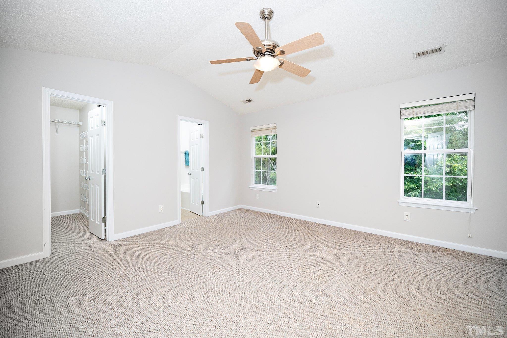 3121 Manhasset Lane Raleigh, NC 27604 - Photo 20 of 25 an empty room with a window and a fan