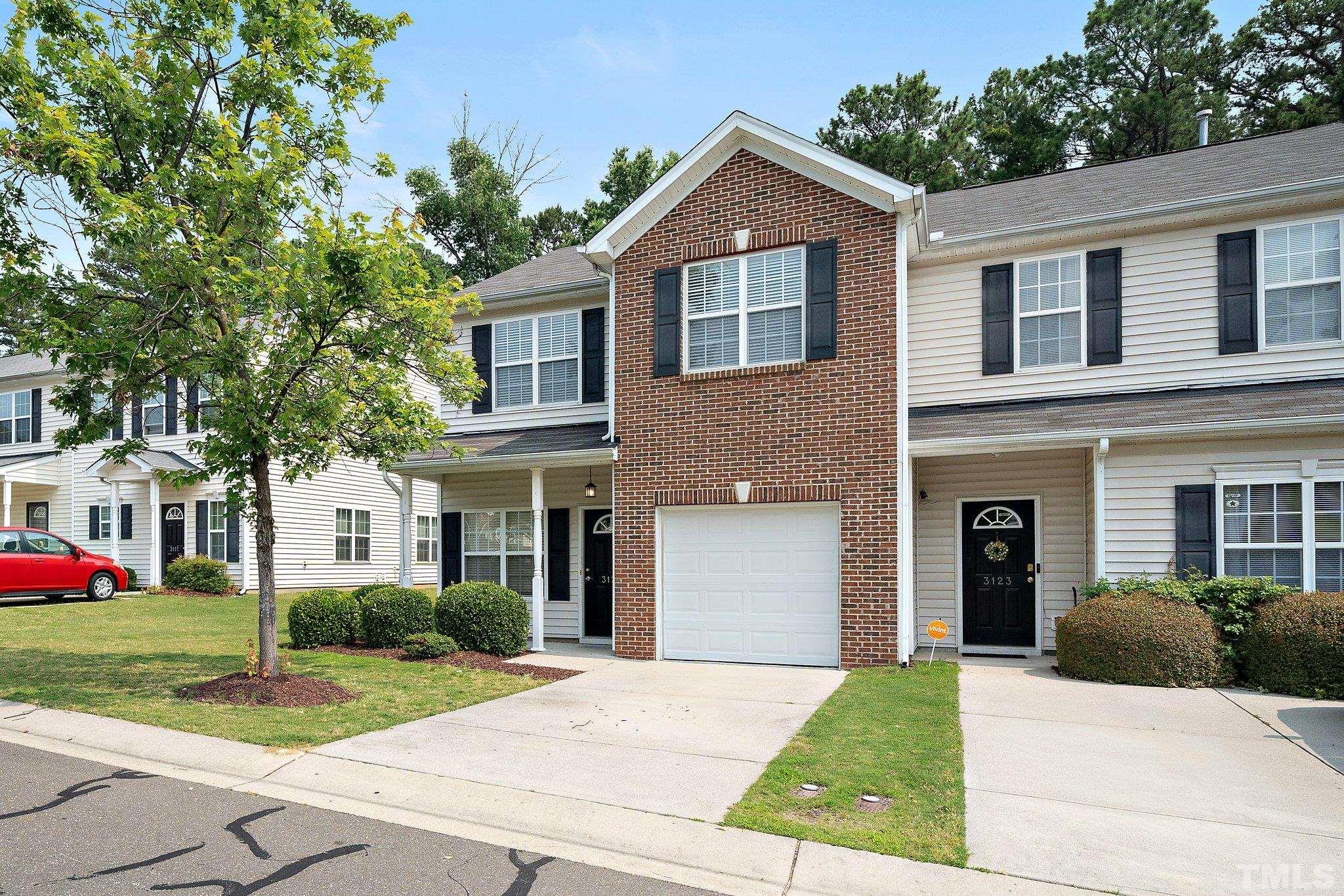 3121 Manhasset Lane Raleigh, NC 27604 - Photo 2 of 25 a front view of a house with a yard and trees