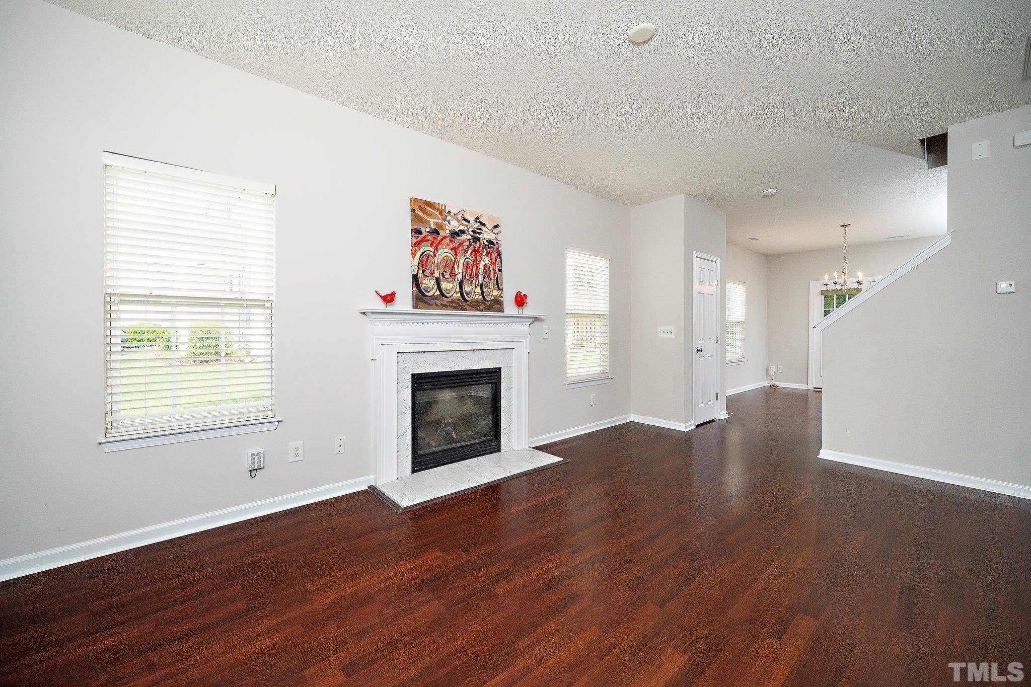 3121 Manhasset Lane Raleigh, NC 27604 - Photo 6 of 25 a view of an empty room with window and wooden floor