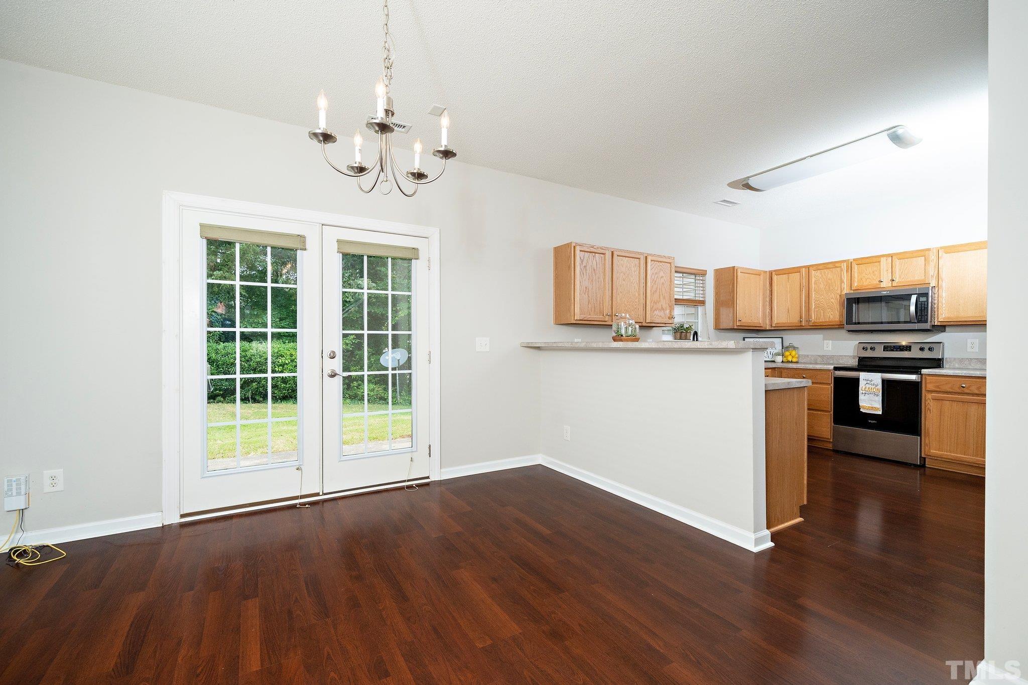 3121 Manhasset Lane Raleigh, NC 27604 - Photo 10 of 25 a view of a kitchen with stove cabinets and wooden floor