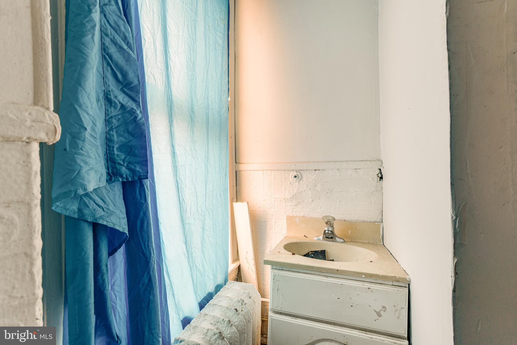 5109 Chester Avenue Philadelphia, PA 19143 - Photo 29 of 34 a bathroom with a sink toilet and tub