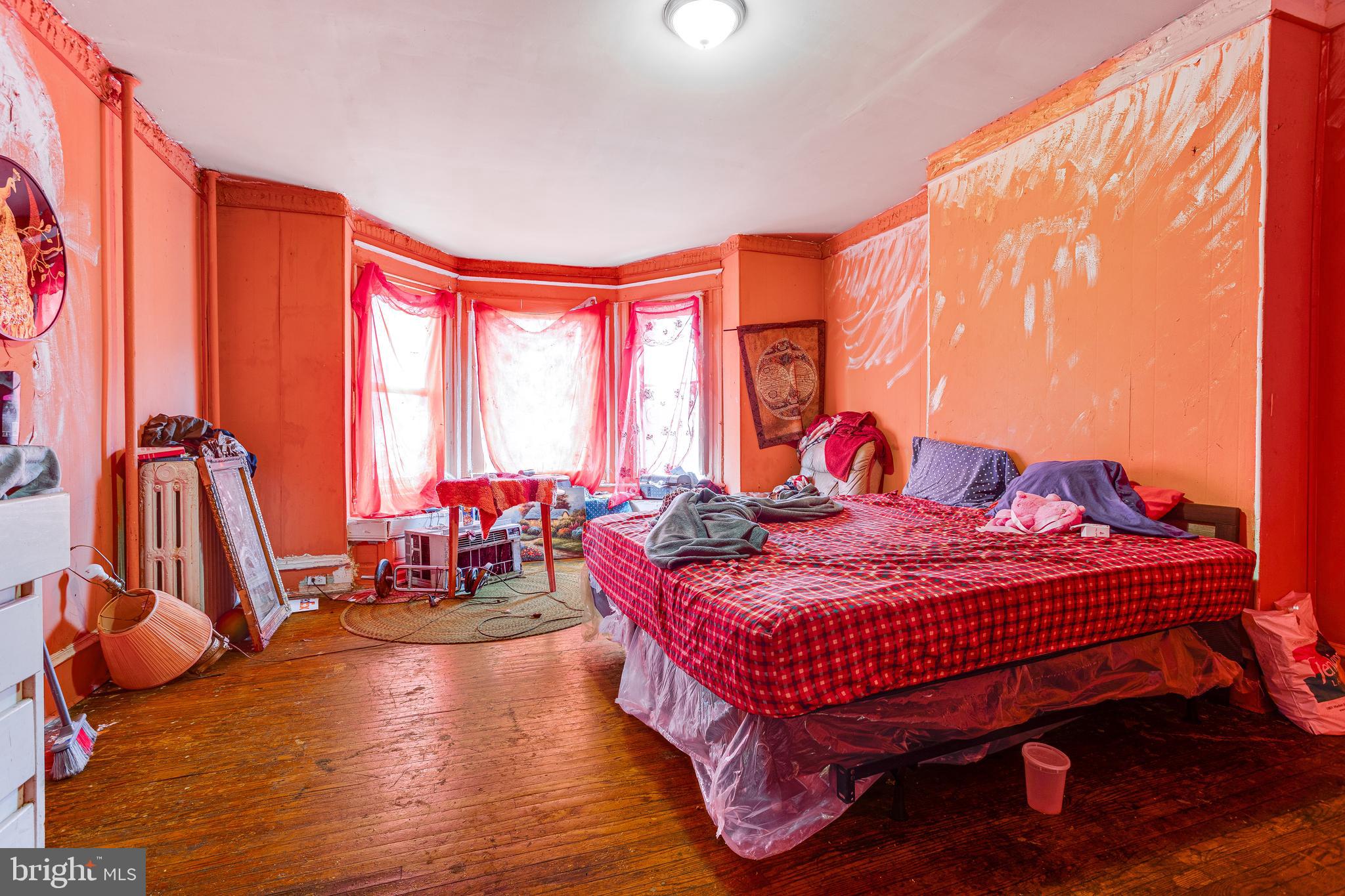 5109 Chester Avenue Philadelphia, PA 19143 - Photo 31 of 34 a bedroom with a bed and large windows