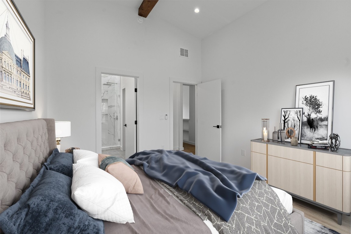 5601 Manor Road, Unit A Austin, TX 78723 - Photo 11 of 35 a bedroom with a bed and dresser with mirror