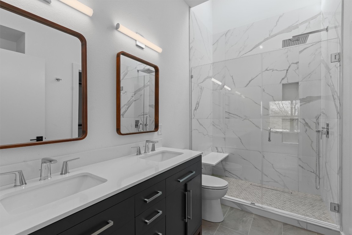 5601 Manor Road, Unit A Austin, TX 78723 - Photo 13 of 35 a bathroom with a double vanity sink toilet and shower