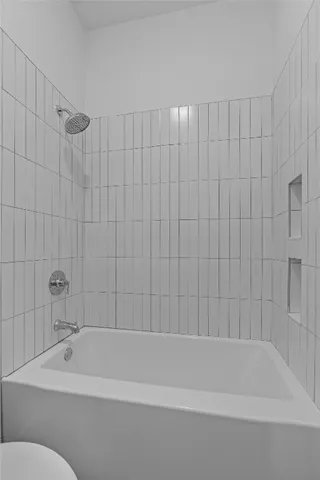 a bathroom with a shower and a bathtub