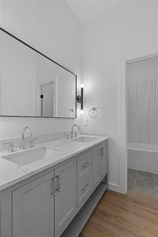 a bathroom with 2 sink and a mirror