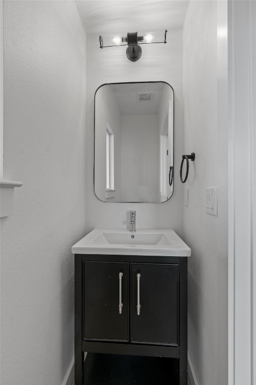 5601 Manor Road, Unit A Austin, TX 78723 - Photo 32 of 35 a bathroom with a granite countertop sink a mirror and vanity