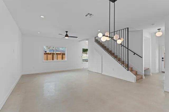 a view of an empty room with stairs