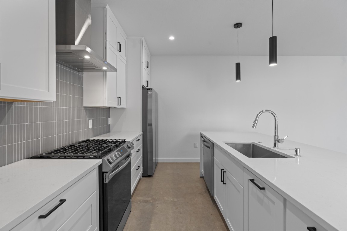 5601 Manor Road, Unit A Austin, TX 78723 - Photo 6 of 35 a kitchen with stainless steel appliances a sink stove and refrigerator