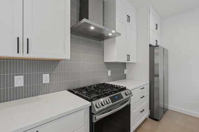 a kitchen with a stove and a refrigerator