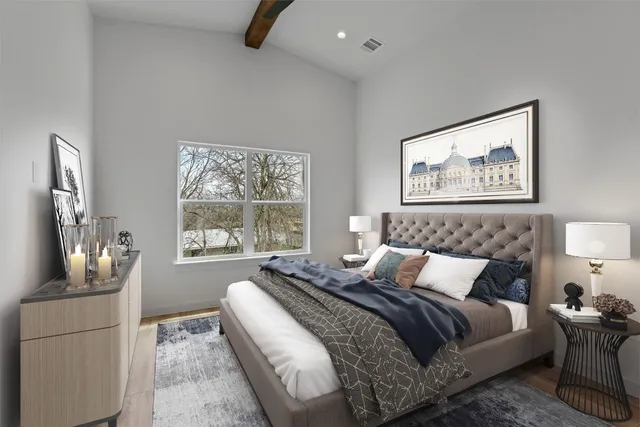 a bedroom with a bed and a painting on the wall