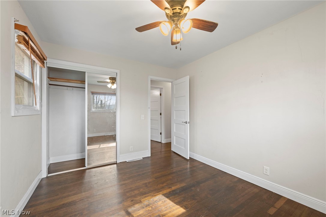 1835 Windham Road Newton Falls, OH 44444 - Photo 16 of 40 Unfurnished bedroom featuring dark wood-style flooring, a ceiling fan, and a closet