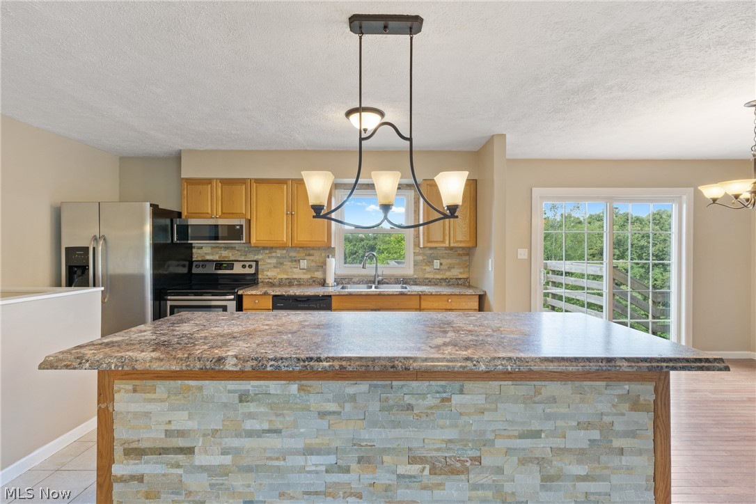 54131 Key Bellaire Road Bellaire, OH 43906 - Photo 21 of 36 Kitchen featuring light hardwood / wood-style floors, sink, stainless steel appliances, and a wealth of natural light