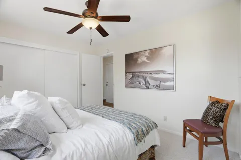 a bedroom with a bed and chair